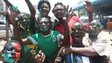 Zambian fans with painted faces celebrate their victory over Ivory Coast