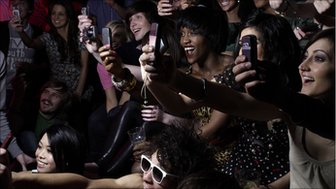A crowd of people with mobile phones