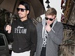 Share your brolly: James Arthur tries to duck his head under team mate Rylan's umbrella as they arrive at their new home