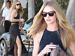 Starting off the week in style: Rosie Huntington-Whiteley flashes some leg in a slinky black dress 